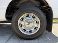 A chrome wheel on a 2014 Ford F-150 with a black tire showcasing a reflective surface