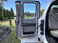 Interior view of a 2016 Ford F-150 passenger door showing the armrest and gray fabric seats