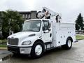 A white 2005 Freightliner M2 106 bucket truck with an elevated work platform and storage compartments on the side