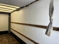 A 2018 Hino 195 truck with an empty interior featuring wooden strips along the walls and a knot tied with a strap hanging from the ceiling