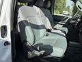 The interior of a 2011 Ford F-250 SD features two gray front bucket seats with seat belts and a console in between