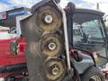 2014 Toro Groundmaster 5910 with three cutting decks visible and grass clippings accumulation on the blades