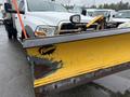 A 2011 Dodge Ram 5500 with a yellow and black Fisher snow plow attached to the front