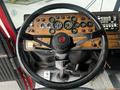 Steering wheel and dashboard of a 1991 Sutphen Deluge with gauges switches and controls prominently displayed