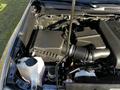 A close-up view of the engine compartment of a 2021 Toyota Tacoma showing components like the air intake and coolant reservoir