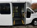 A 2017 Chevrolet Express with its side doors open revealing an interior ramp and seating area designed for accessibility