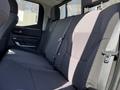 The image shows the interior of a 2023 Toyota Tundra with a spacious back seat featuring cloth upholstery and seat belts