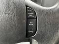 Close-up of a black steering wheel with cruise control buttons labeled RES SET ACCEL and COAST