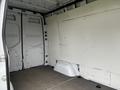A 2021 Mercedes-Benz Sprinter interior with plain walls and a flat floor featuring partially enclosed cargo space