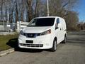 A white 2017 Nissan NV200 van is parked on the street with a closed rear cargo area and a compact design suitable for urban driving