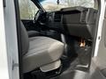 Interior of a 2015 Chevrolet Express showing driver and passenger seats with a dashboard and steering wheel in view