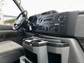 Interior view of a 2014 Ford Econoline showing the dashboard controls steering wheel and cup holders