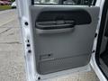 A 2007 Ford F-550 door panel featuring a gray armrest and a textured surface for grip