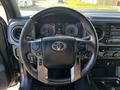 Interior view of a 2021 Toyota Tacoma showing the steering wheel with controls and dashboard displays