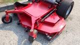 A red 2014 Ferris Mower ISX 800 with a low-profile cutting deck and large rear wheels designed for commercial lawn maintenance