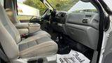 Interior of a 2007 Ford F-550 showing gray upholstery on the driver and passenger seats and a black dashboard with controls