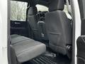 Interior view of a 2021 Chevrolet Silverado 3500HD showing the rear seating area with two leather-trimmed seats and a spacious floor area