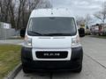 A 2021 RAM Promaster van with a white exterior and a black grille featuring the RAM logo prominently displayed in the center