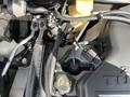 A close-up view of the engine compartment of a 2005 Chrysler PT Cruiser showing various components including hoses, wires, and the engine cover
