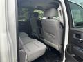 Interior view of the back seats of a 2016 GMC Sierra 1500 with grey fabric upholstery and a spacious seating area