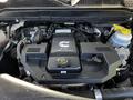 Engine compartment of a 2022 RAM 3500 featuring a 6.7L turbo diesel engine with various components including hoses and a coolant reservoir