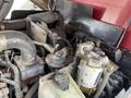 A close-up view of a 2014 Toro Groundmaster 5910 engine compartment showing various components including pipes filters and a reservoir