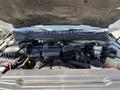 Close-up of the engine compartment of a 2017 Ford F-350 SD showing the engine block air intake and various components including the battery and coolant reservoir