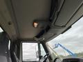 Interior view of a 2014 International Durastar truck showing the ceiling and overhead controls with a light and mesh storage compartment