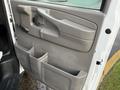 Interior door panel of a 2015 GMC Savana showing storage compartments and controls
