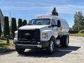 A 2019 Ford F-750 truck with a white and black color scheme featuring a large, rounded tank on the back and a prominent grille showcasing the Ford logo