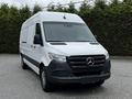 A 2019 Mercedes-Benz Sprinter van with a white exterior and black grille parked on a gravel surface