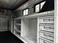 Interior of a 2013 Ford Econoline with white storage compartments and drawers organized for utility or transport purposes