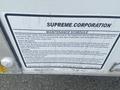 2004 Ford Econoline van with a maintenance schedule notice affixed to its side detailing inspection intervals and safety precautions for body mounts and water damage prevention