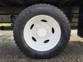 A close-up view of a white wheel with a black tire labeled AD778 on a 2014 International TerraStar vehicle