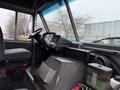 Interior of a 2012 Ford Econoline showing the driver's seat steering wheel dashboard and control panel