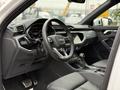 Interior view of a 2024 Audi Q3 featuring a modern dashboard a steering wheel with controls and leather seats