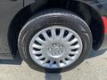 Close-up of a black wheel with a silver rim featuring ten spokes mounted on a Goodyear tire