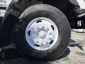A close-up of a white wheel from a 2008 International 7500 featuring a Bridgestone tire with visible tread and lug nuts