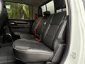 A 2024 RAM 5500 featuring a spacious and modern interior with black leather seats and a red seatbelt on the rear bench