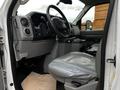 Interior view of a 2011 Ford Econoline showing the driver's seat dashboard and steering wheel