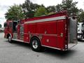 A red 1991 Sutphen Deluge fire truck with chrome wheels and various equipment compartments visible on the side.