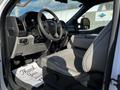 Interior view of a 2018 Ford F-550 showing a beige driver's seat steering wheel and dashboard elements