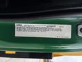 A 2015 Freightliner M2 106 vehicle noise emissions control information label attached to the truck body