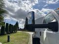 A 2016 Ford F-750 truck featuring a prominent side mirror reflecting surrounding scenery and showcasing its robust design