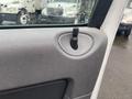 Close-up of the interior door panel of a 2008 Dodge Ram 5500 showing a small black door handle and textured gray material