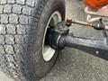 Close-up of the rear wheel axle assembly of a 2007 New Holland TN70A tractor showing the tire and hub details