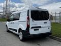 A 2016 Ford Transit Connect van parked with a white exterior and black accents