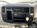 Dashboard of a 2004 Toyota Toyoace featuring control knobs for air conditioning and audio system along with a cassette player and digital clock display