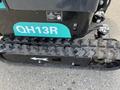 2024 AGT Industrial Green QH13R Mini Excavator with a tracked undercarriage and teal branding on the side