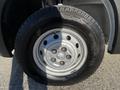 A close-up view of a silver wheel and tire from a 2021 RAM Promaster showcasing the tire tread and rim detailing